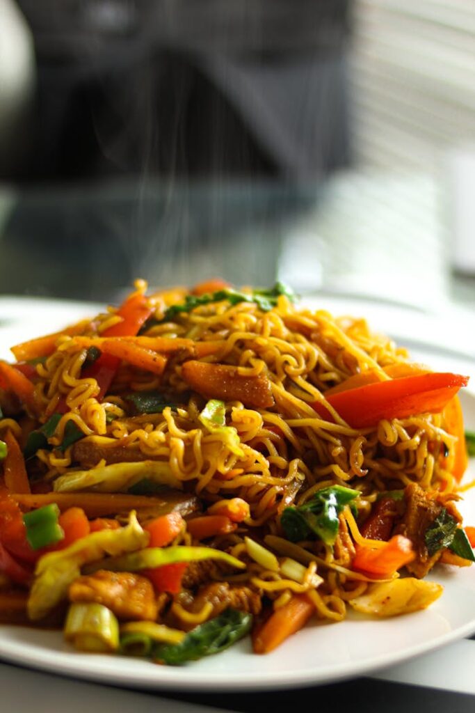 Delicious Asian noodles served hot with mixed vegetables and spices.